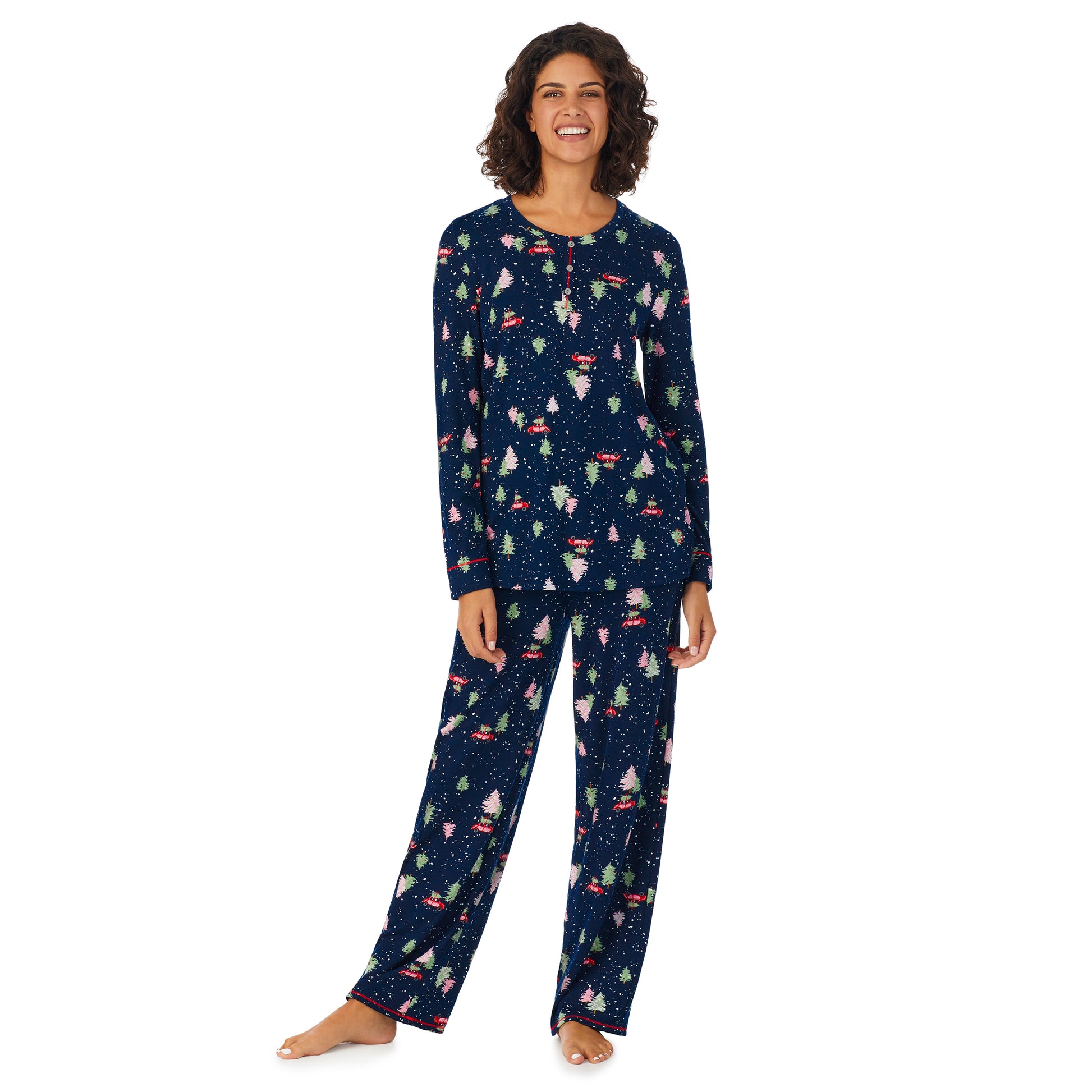 A lady wearing a navy long sleeve pajama set with tree hunting pattern.