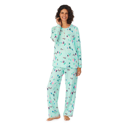 Teal Penguin; Model is wearing size S. She is 5’9”, Bust 32”, Waist 24”, Hips 34.5”. @A lady wearing a teal long sleeve pajama set with penguins pattern.