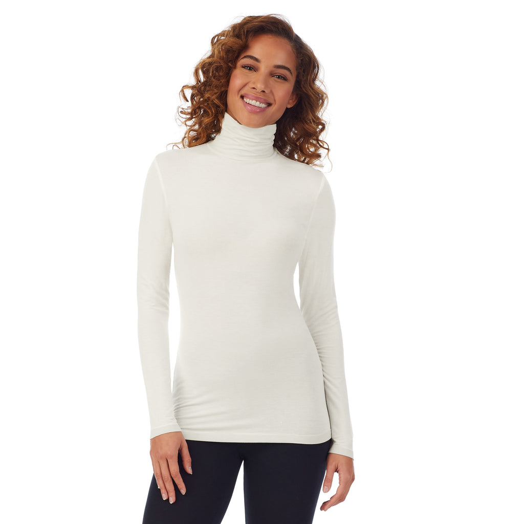 A lady wearing a ivory long sleeve stretch tutleneck t-shirt.