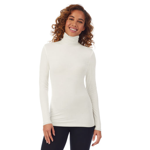 Ivory; Model is wearing size S. She is 5’9”, Bust 34”, Waist 23”, Hips 35”. @A lady wearing a ivory long sleeve stretch tutleneck t-shirt.