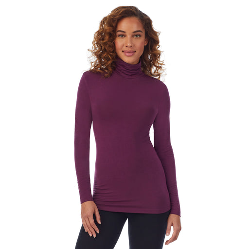 Grape; Model is wearing size S. She is 5’9”, Bust 34”, Waist 23”, Hips 35”. @A lady wearing a grape long sleeve stretch tutleneck t-shirt.