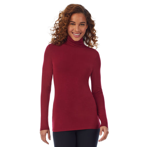 Rhubarb; Model is wearing size S. She is 5’9”, Bust 34”, Waist 23”, Hips 35”. @A lady wearing a rhubarb long sleeve stretch tutleneck t-shirt.