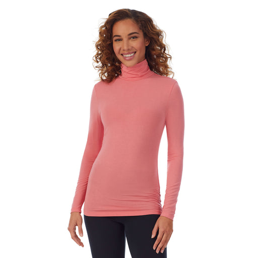 Bright Coral; Model is wearing size S. She is 5’9”, Bust 34”, Waist 23”, Hips 35”. @A lady wearing a bright coral long sleeve stretch tutleneck t-shirt.