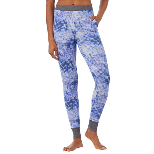 Blue Tie Dye; Model is wearing size S. She is 5’9”, Bust 32”, Waist 25.5”, Hips 36”. @A lady wearing a blue tie dye legging.