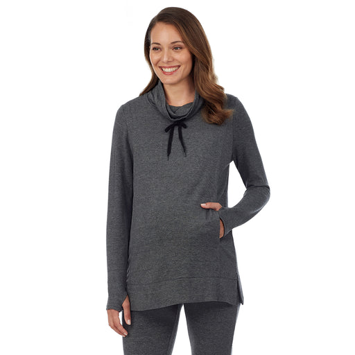 A lady wearing a charcoal heather long sleeve funnel neck tunic. 
