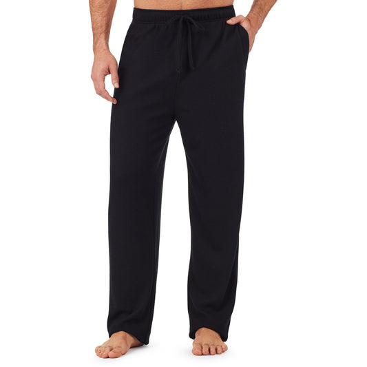 A man wearing a black waffle thermal relaxed pant.