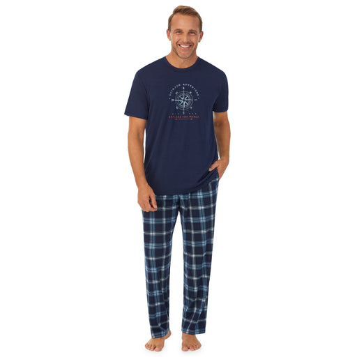 A man wearing short sleeve graphic tee and pant pajama set.