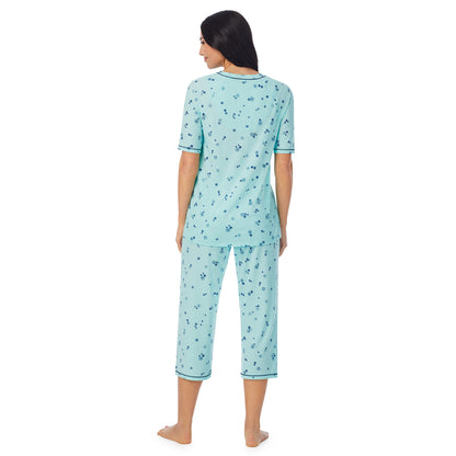 Mint Ditsy Floral;Model is wearing size S. She is 5'8.5", Bust 32", Waist 25", Hips 36".@ A lady wearingCuddl Smart Elbow Sleeve Top with Cropped Pant Pajama Set with Mint Ditsy Floral print