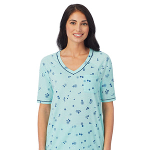  A lady wearingCuddl Smart Elbow Sleeve Top with Cropped Pant Pajama Set with Mint Ditsy Floral print