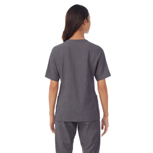 A lady wearing charcoal heather scrub split neck top.