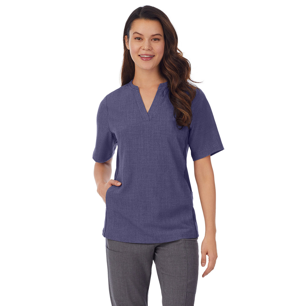 A lady wearing navy heather scrub split neck top.