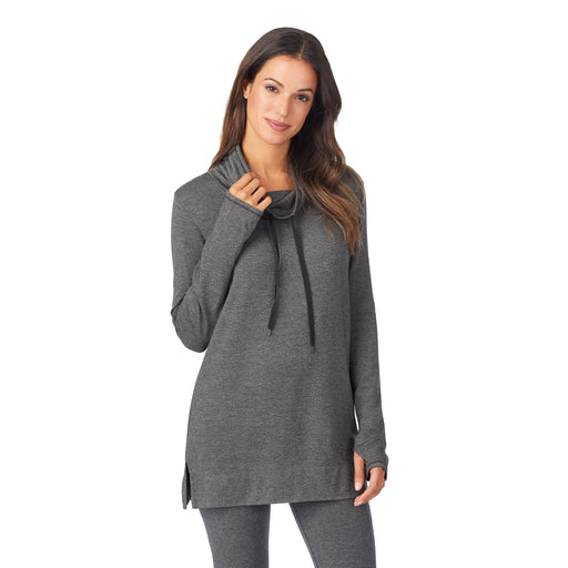 A lady wearing a charcoal heather long sleeve cowl neck tunic.