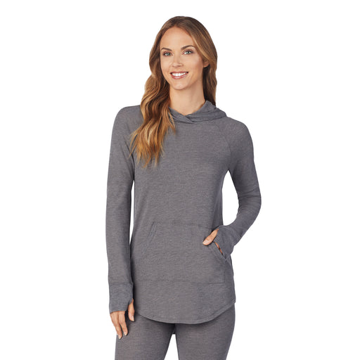 A lady wearing a stone grey heather long sleeve hoodie tunic.