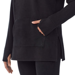 upper body of a lady wearing black long sleeve tunic