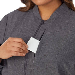 A lady wearing charcoal heather scrub jacket plus.