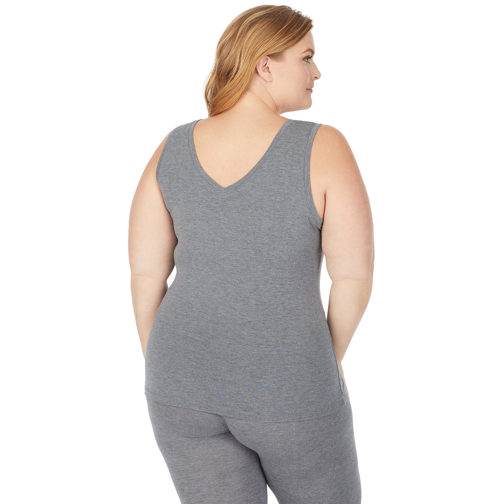 A lady wearing a charcoal heather sleeveless reversible tank plus.