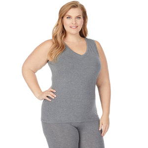 A lady wearing a charcoal heather sleeveless reversible tank plus.