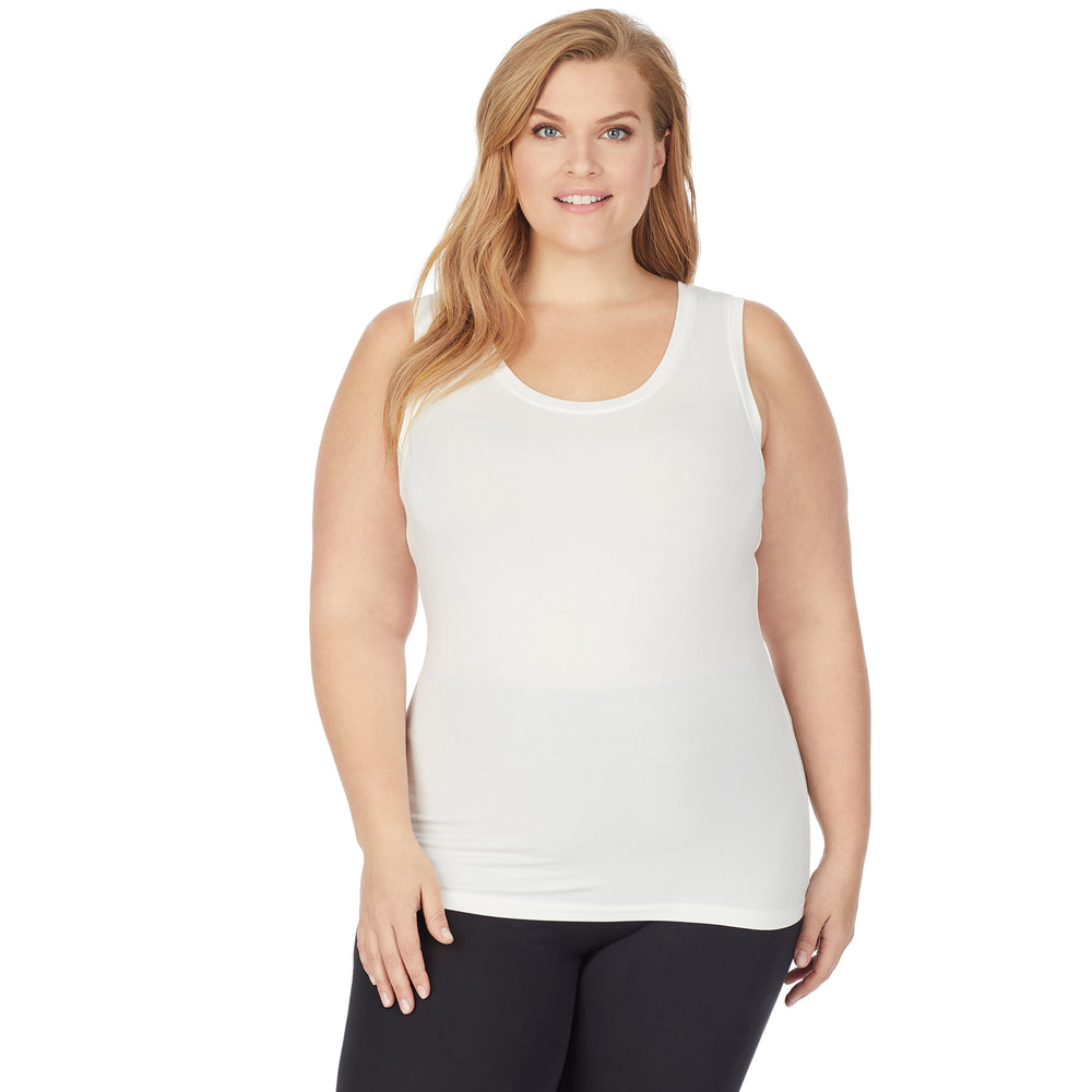A lady wearing a ivory sleeveless reversible tank plus.