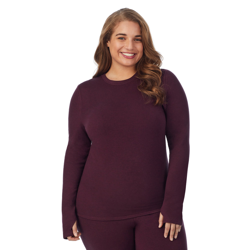 A lady wearing grape heather long sleeve crew plus.