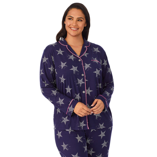 Navy Star; Model is wearing size 1X. She is 5’11”, Bust 38”, Waist 34”, Hips 46”. @A lady wearing a navy long sleeve notch pajama set plus with star pattern.