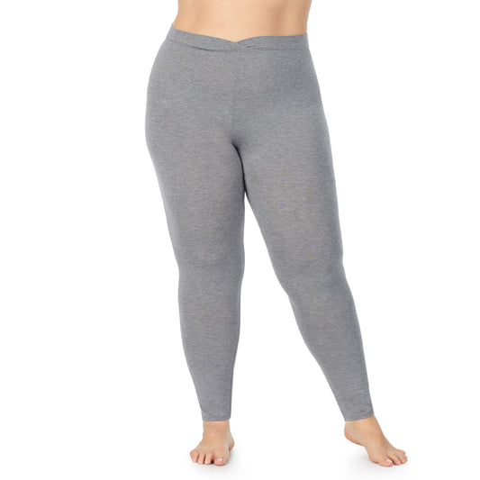A lady wearing a charcoal heather stretch legging plus.