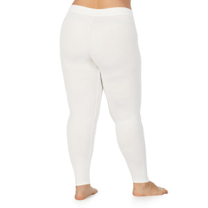 A lady wearing a ivory stretch legging plus.