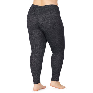 A lady wearing a marled dark charcoal legging plus.