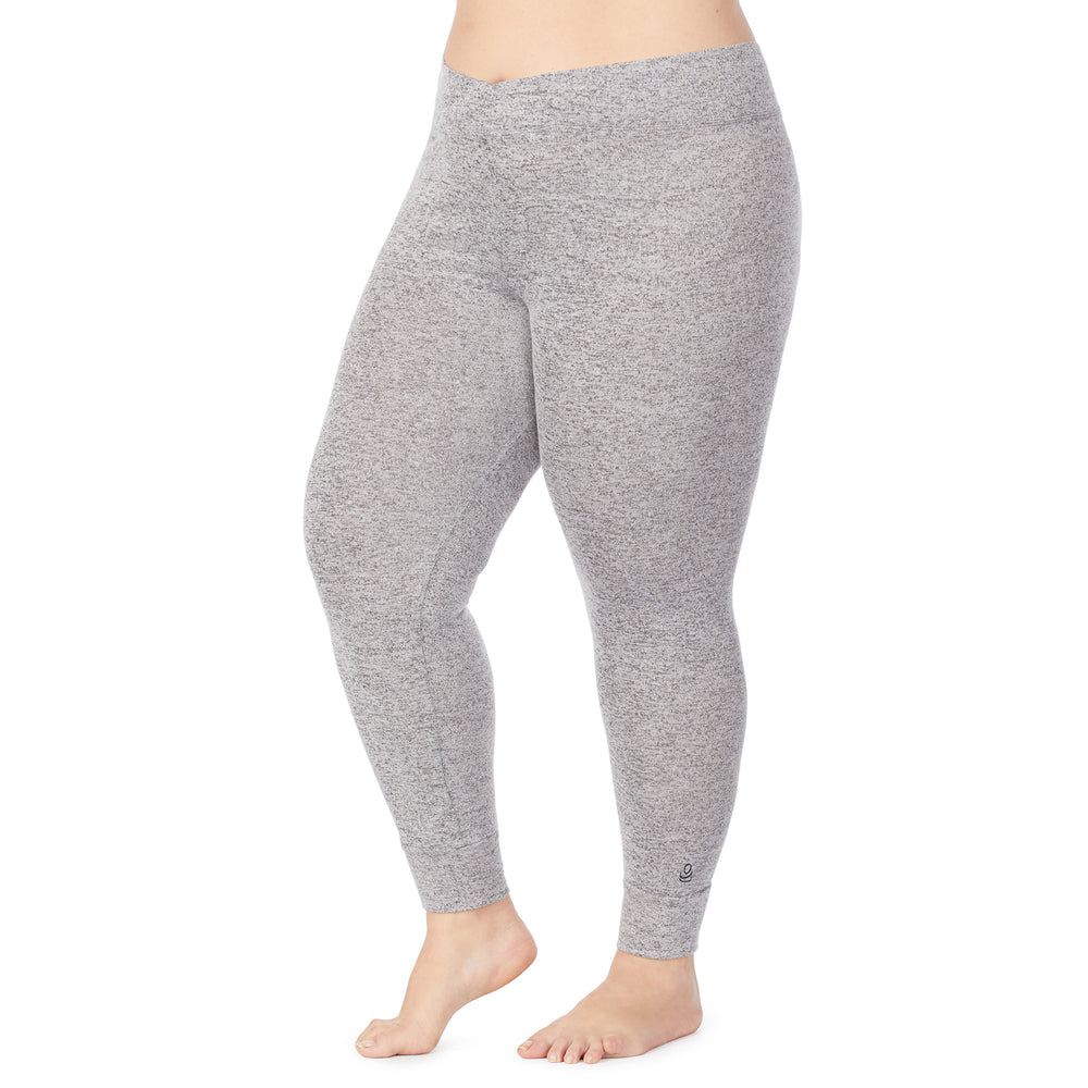 A lady wearing a marled grey legging plus.