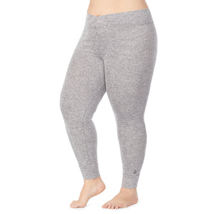 A lady wearing a marled grey legging plus.