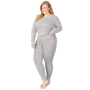A lady wearing a marled grey legging plus.