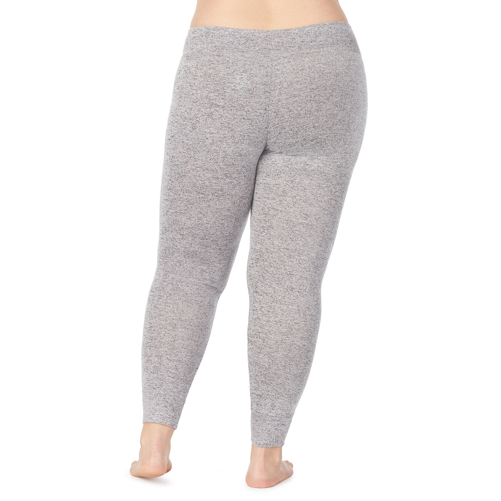 A lady wearing a marled grey legging plus.