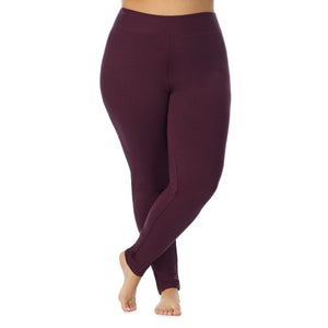 A lady wearing a grape heather legging plus.