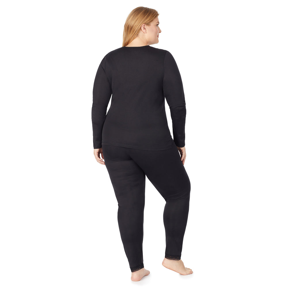 A lady wearing a black lace edge legging plus.