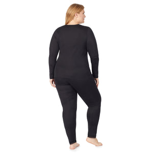 A lady wearing a black lace edge legging plus.