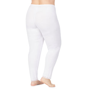 A lady wearing a white lace edge legging plus.