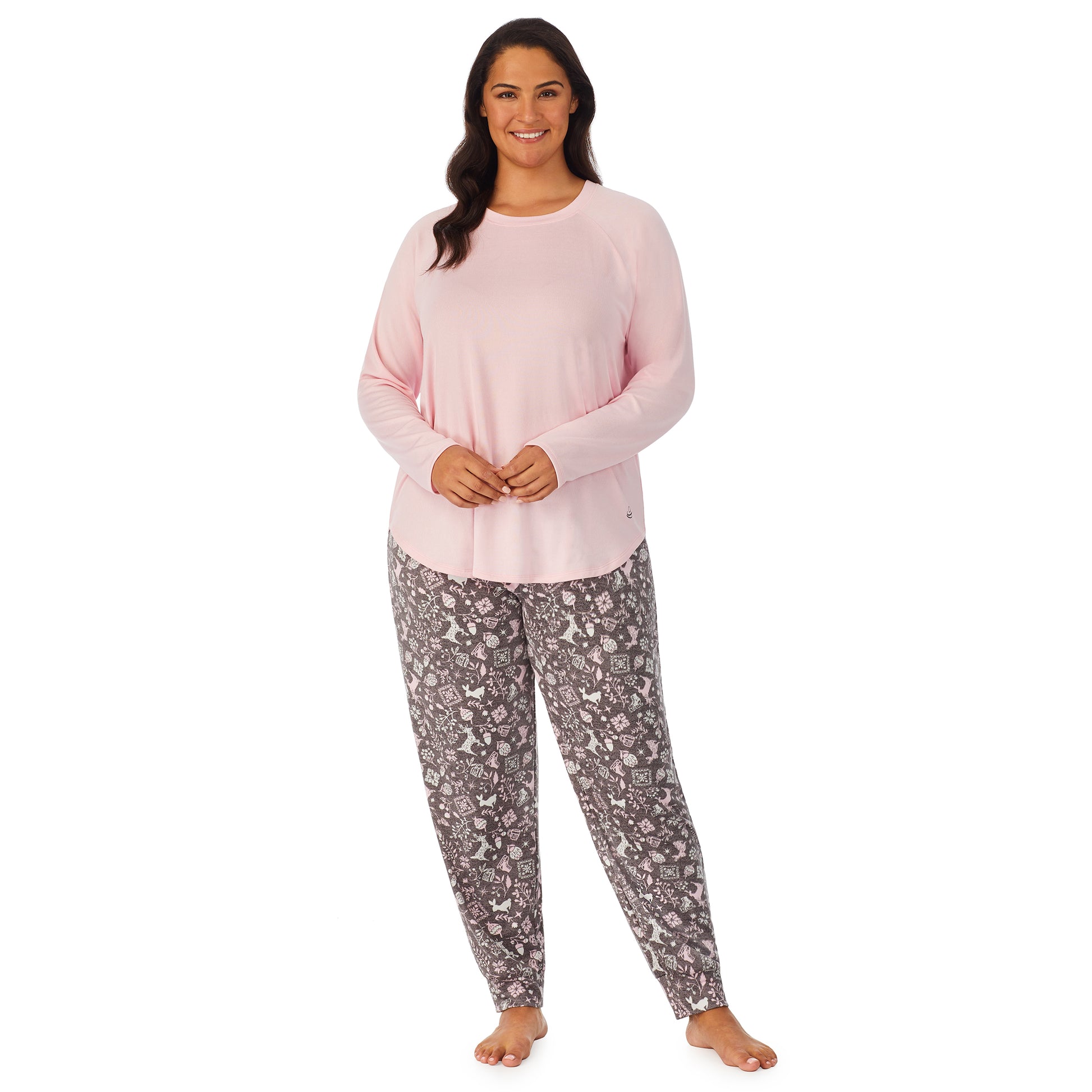 A lady wearing a pink long sleeve top and bottom pajama set with nordic pattern.