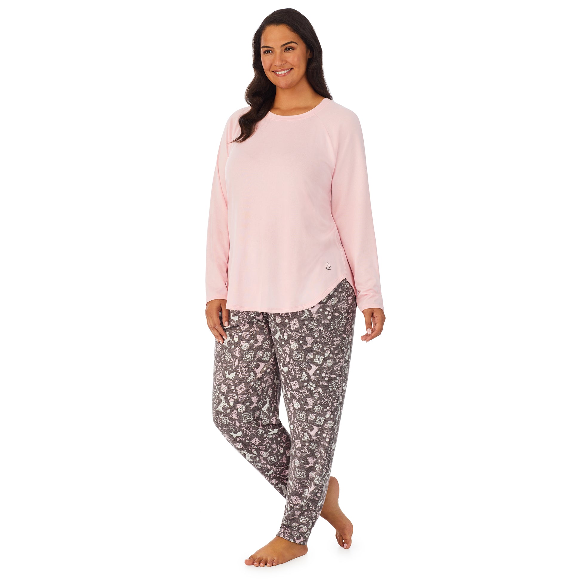 A lady wearing a pink long sleeve top and bottom pajama set with nordic pattern.