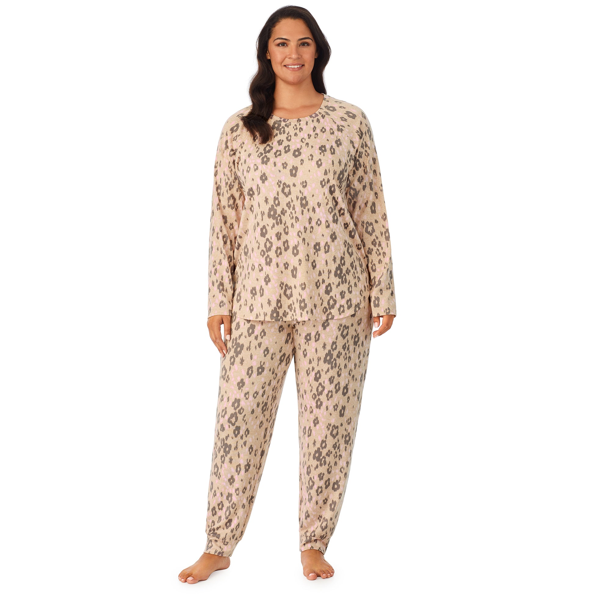 A lady wearing a beige long sleeve pajama set with leopard pattern. 