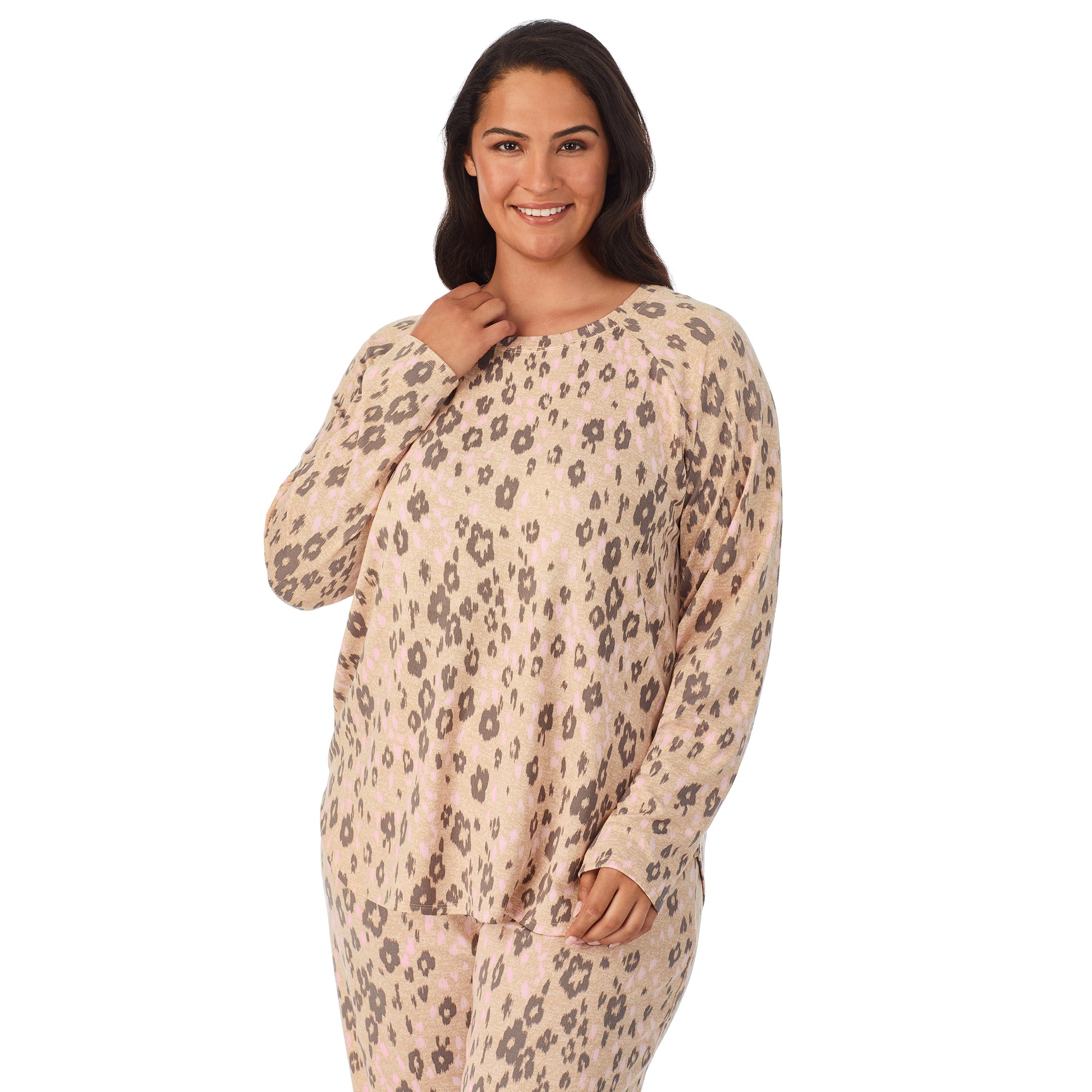 A lady wearing a beige long sleeve pajama set with leopard pattern.