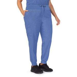 A lady wearing ceil heather scrub jogger pant plus.