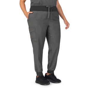 A lady wearing charcoal heather scrub jogger pant plus.