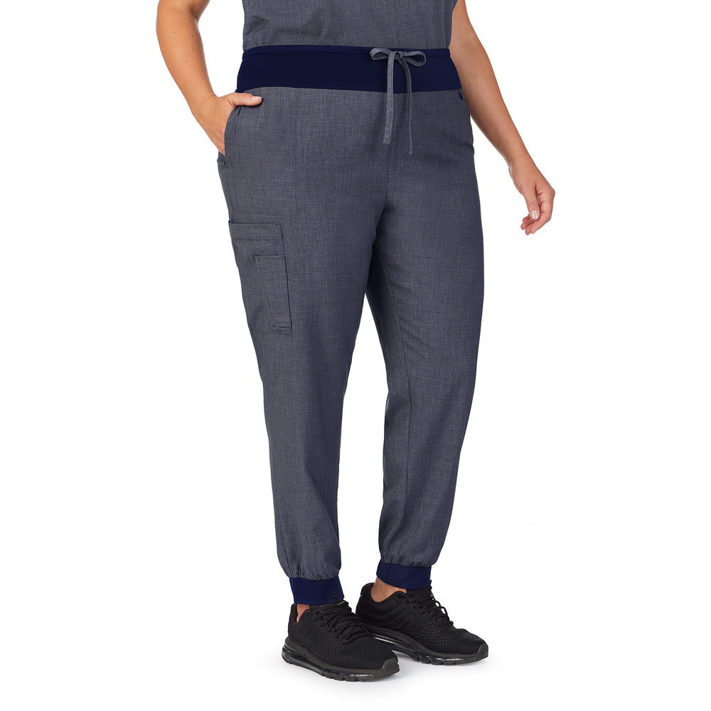 A lady wearing navy heather scrub jogger pant plus.