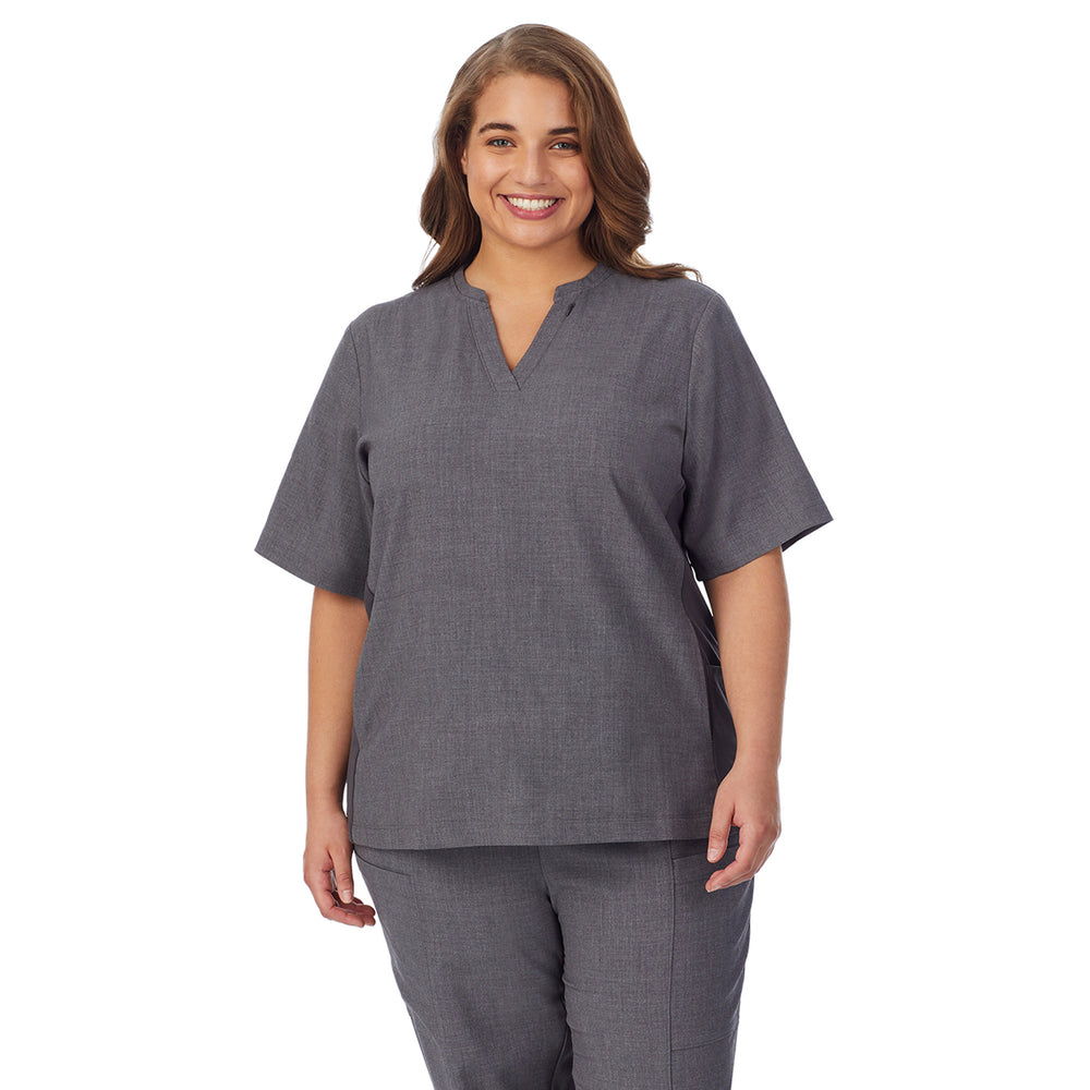 A lady wearing charcoal heather scrub split neck top plus.