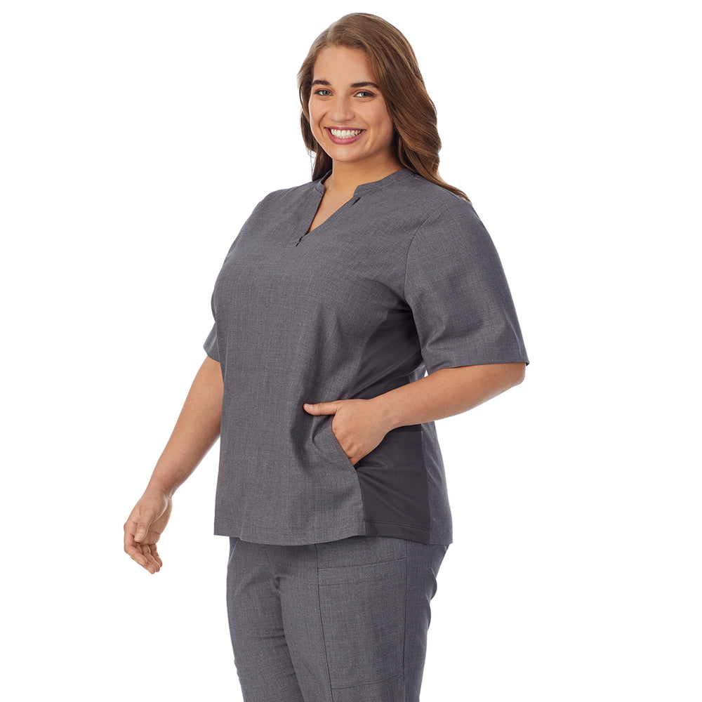 A lady wearing charcoal heather scrub split neck top plus.