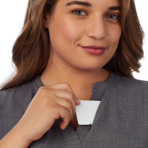  A lady wearing charcoal heather scrub split neck top plus.