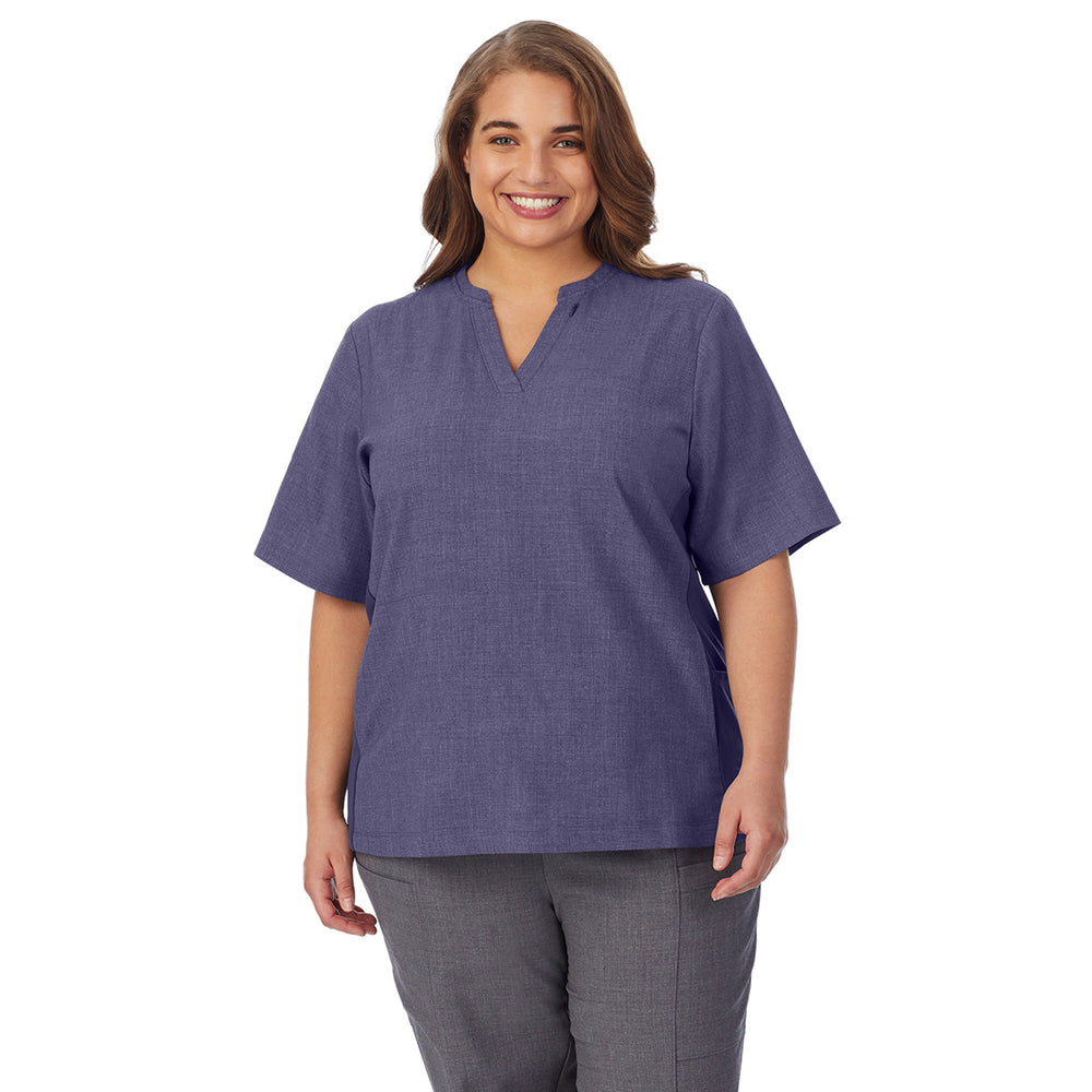 A lady wearing navy heather scrub split neck top plus.