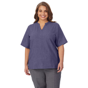  A lady wearing navy heather scrub split neck top plus.