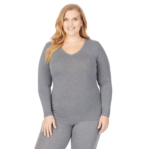 upper body of a lady wearing grey long sleeve v-neck top