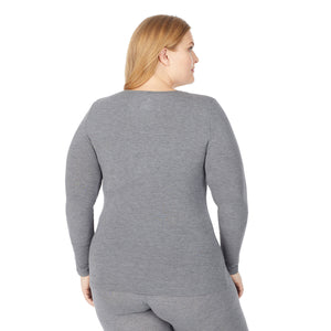 upper body of a lady wearing grey long sleeve v-neck top