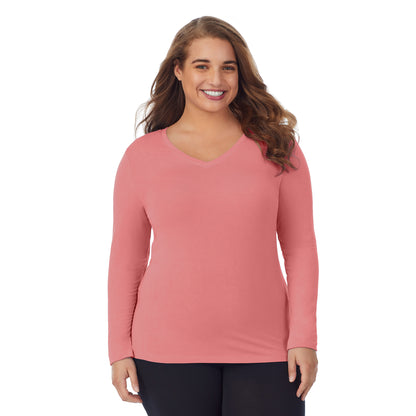 Bright Coral; Model is wearing size 1X. She is 5'7", Bust 42.5", Waist 34.5", Hips 46".@upper body of a lady wearing bright coral long sleeve v-neck top